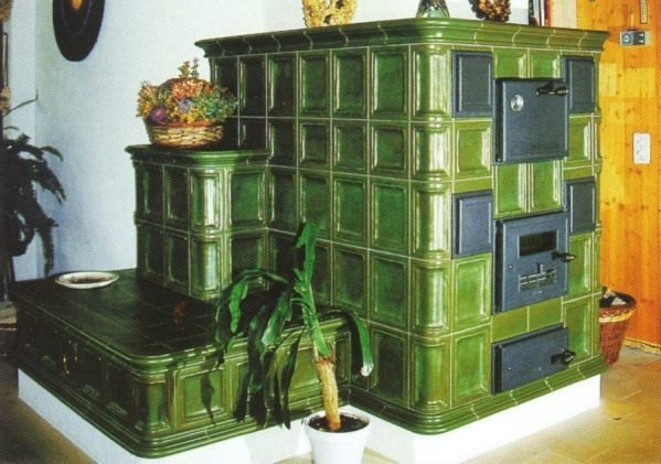 Classic green tiled stove with bench, historical style, cozy atmosphere